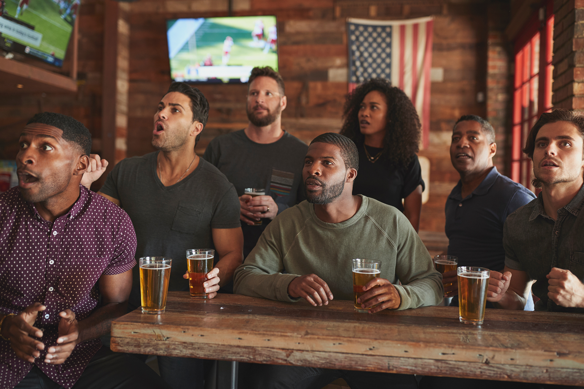 Sports fans watching games at an American sports bar and restaurant.