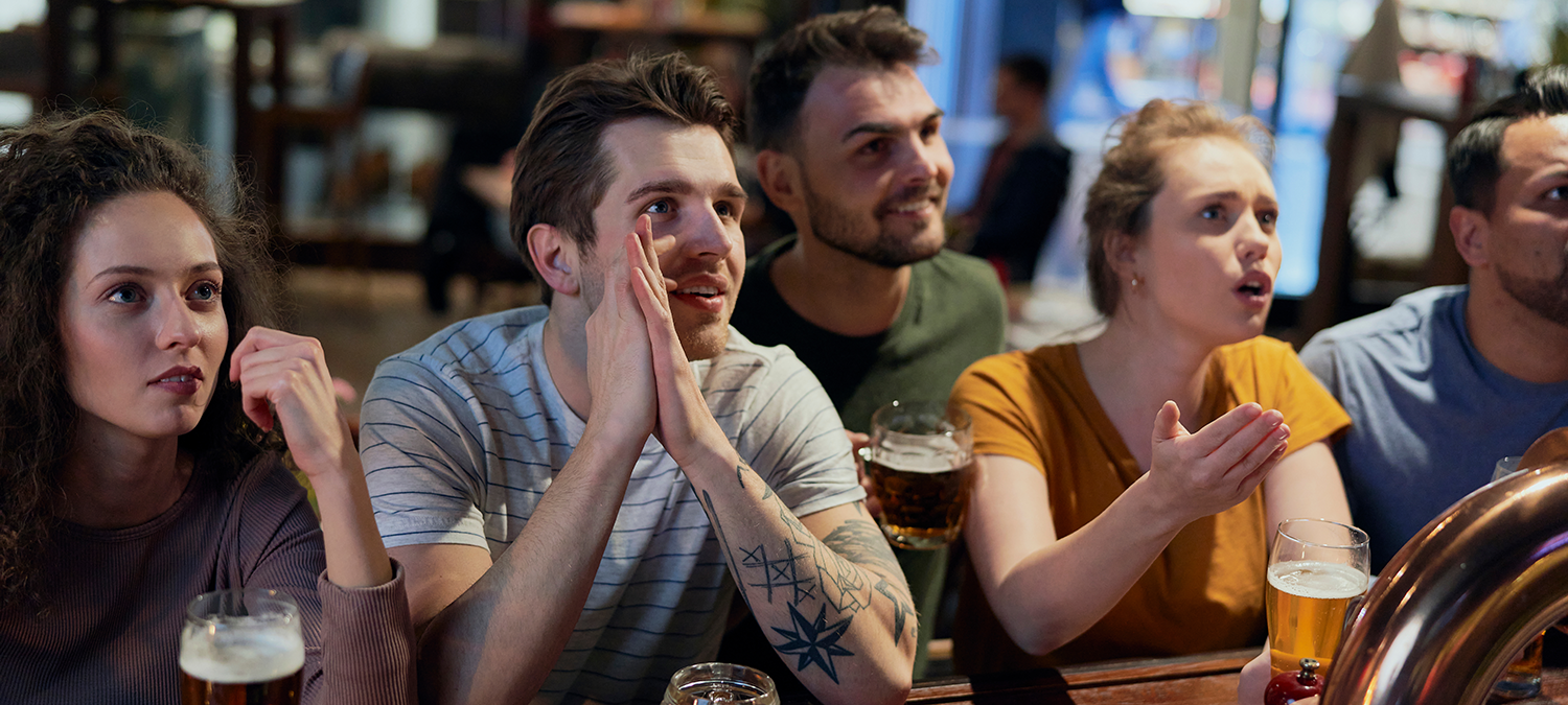 Anxious sports fans watching the game at a sports bar