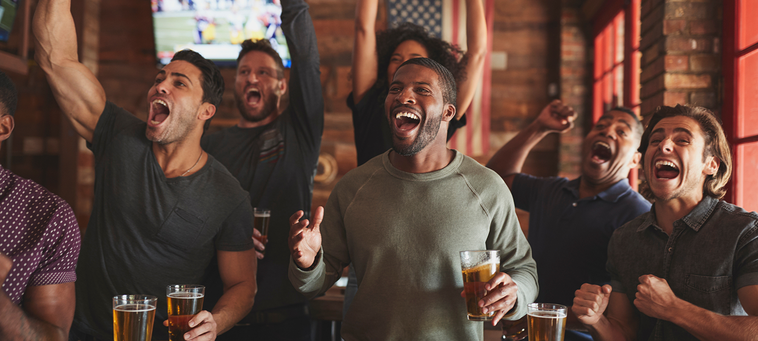 Sports fans celebrating at a US sports bar