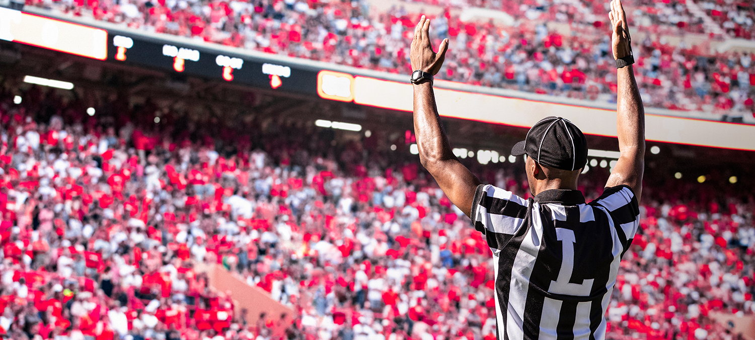 A ref gestures a touchdown during a football game